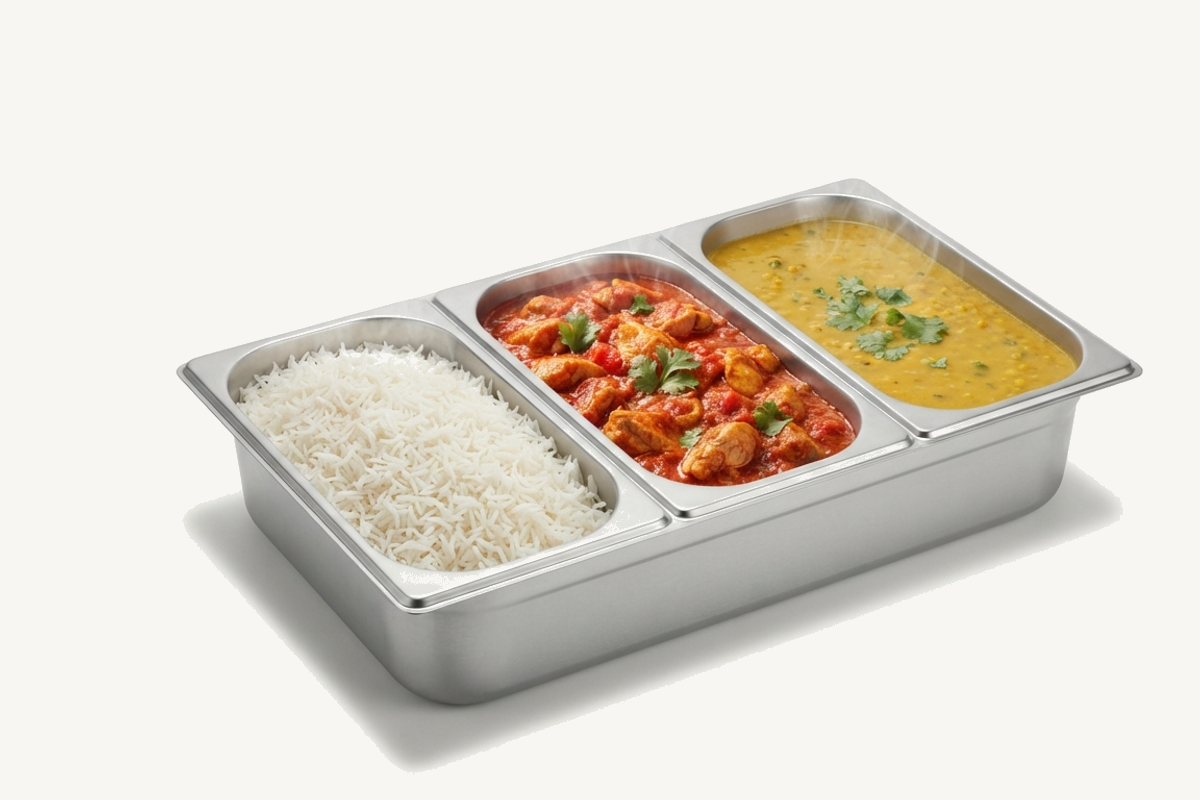 Stainless steel bain-marie with rice, chicken curry and dal, on a corporate cafeteria counter