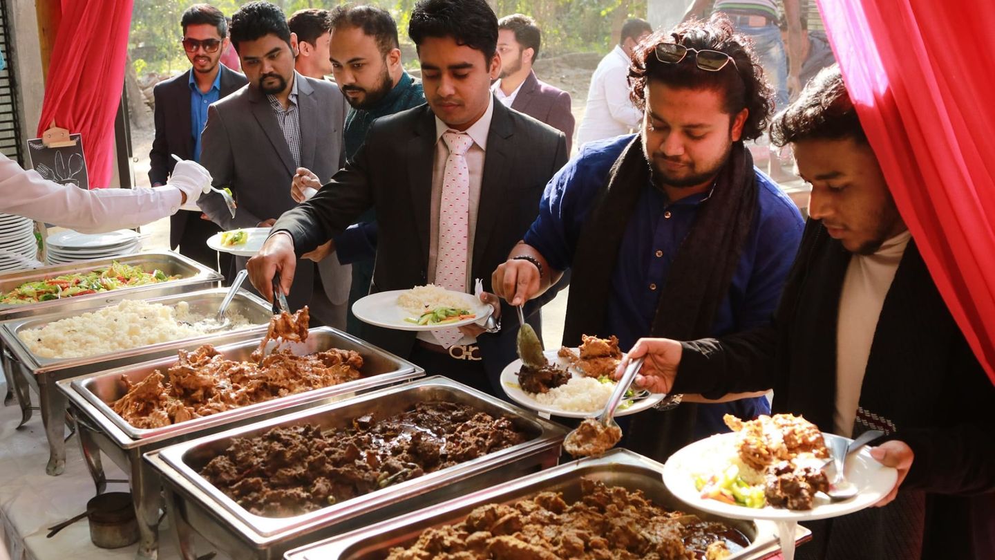 Buffet line with polao, roast chicken, and kabab being served at a corporate event in Dhaka