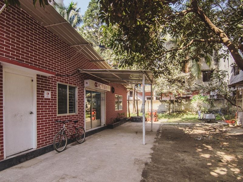 The Alpha Catering central kitchen in Cantonment, a red brick building with the Alpha sign above the entrance