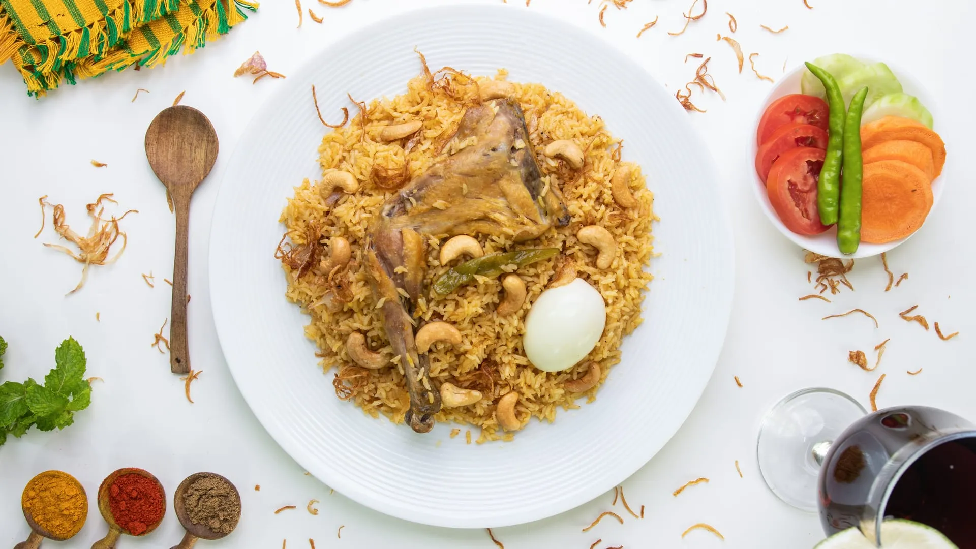 A packed set platter with polao, chicken roast, jali kabab and boiled egg, boxed for delivery